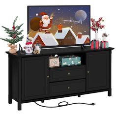 a flat screen tv sitting on top of a black entertainment center next to a christmas tree