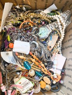 a box filled with lots of different types of jewelry