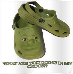 two green crocs with faces on them