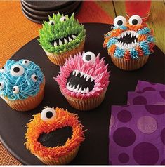 cupcakes decorated to look like monsters on a plate