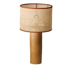 a lamp that is sitting on top of a wooden pole with a light shade over it