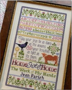 a cross stitch sample with the words home sweet home and an image of a bird