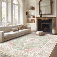 a living room filled with furniture and a fire place in front of a large window