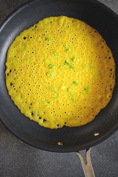 an omelet is cooking in a frying pan