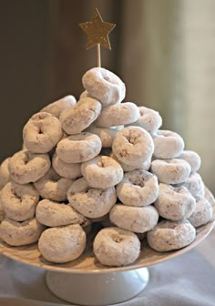 a white plate topped with donuts covered in powdered sugar