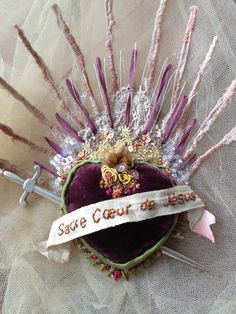 the crown is adorned with purple feathers and ribbons that read safe court, do not