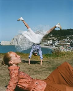 a woman laying on the ground with her legs in the air