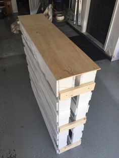 a stack of unfinished wood sitting in front of a door