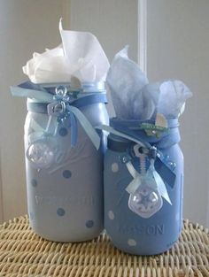 two blue mason jars with white polka dots and ribbon, one is filled with tissue