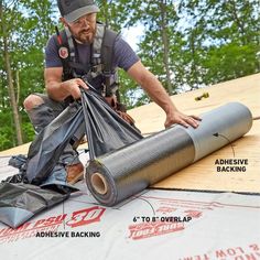 a man is working on the roof of a house that has been wrapped in tarp