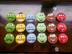 there are many different colored cookies with faces on them