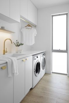 a washer and dryer in a white laundry room