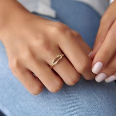 a woman's hand with a ring on her finger