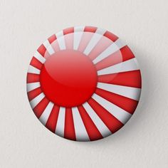 a red and white button with the japanese flag on it