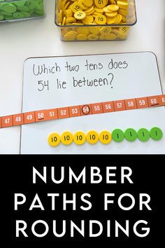 a table topped with lots of coins next to a sign that says number paths for rounding