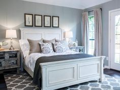 a bedroom with gray walls and white furniture