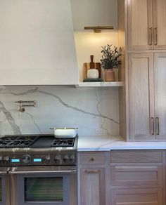 a stove top oven sitting inside of a kitchen next to wooden cupboards and counter tops