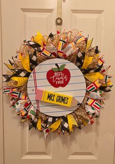 a wreath that has been made to look like a teacher's apple on it