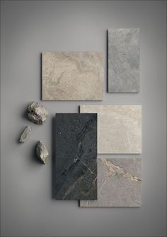 several different types of marbles and rocks on a gray background