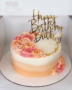 a birthday cake decorated with pink and gold flowers