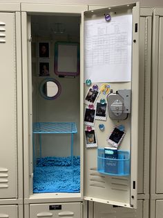 an open locker with pictures and other items on the door, inside which is blue carpet