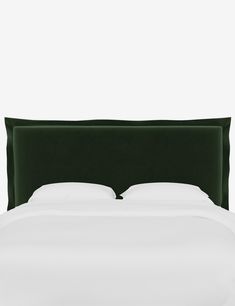 a bed with white sheets and green headboard