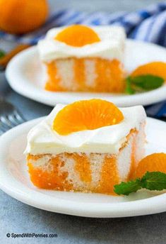 two white plates topped with slices of cake and orange slices on top of each plate