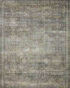 an antique rug with many different colors and patterns on the carpet, including greys