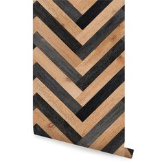 a wooden wall hanging with black and brown chevrons