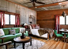 a living room filled with furniture and wooden walls