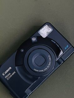 a black digital camera sitting on top of a table