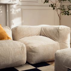 a living room with two white couches and a black and white checkered rug