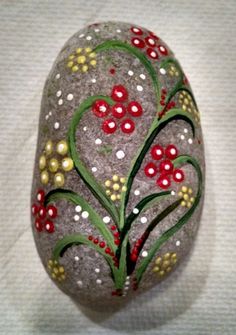 a painted rock sitting on top of a white table