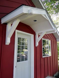 a red house with a white door and window