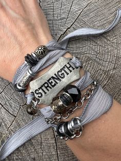 'Strength' - "You were given this life because you were Strong enough to live it"  These bracelets are meant to inspire and empower the wearer!  You can overcome anything!   Silk ribbon with silver chains and glass and crystal bead accents, metal 'STRENGTH' curved tag. Choose your color from the options shown!   Check out more Silk Ribbon Wrap Bracelets here: https://www.etsy.com/shop/gennextjewelry?section_id=18514502&ref=shopsection_leftnav_6 Sizing: All Bracelets are made to fit 7-8" wrists.  If you need something smaller or larger, please mention the length needed when checking out.  I can of course make custom fits.   Guarantee: All my designs are handcrafted with FUN in mind! I love creating pieces thinking about a Fearless Female getting ready to go to a Club, or a Boho Chic Chick r Trendy Jewelry Ideas, Women Survivor, Silk Wrap Bracelets, Ribbon Bracelets, Inspirational Bracelets, Ribbon Wrap, Bride Getting Ready, Silver Chains, Wrap Bracelets