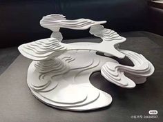 a white sculpture sitting on top of a table