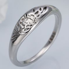 a silver ring with an intricate design on it