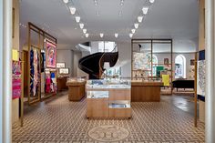 the inside of a store with many items on display and lights hanging from the ceiling