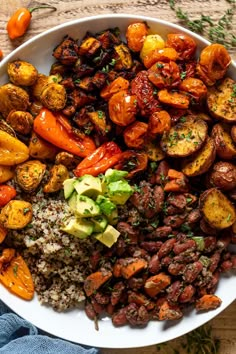 a white plate topped with lots of different types of food on top of a wooden table