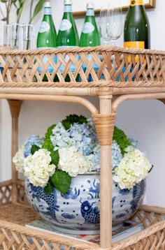 a wicker shelf with vases and bottles on it