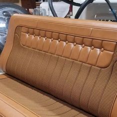 the interior of a car with tan leather upholstered and stitching on it