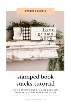 a stack of books sitting on top of a white shelf next to a green plant