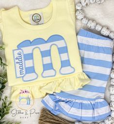 Girls Monogram Shirt Outfit/Personalized yellow/blue Summer Set/Monogram/Stripe Ruffle Short Outfit/Toddler Monogram Shirt/Spring Shirt Select Shirt Size Select Short Size or no shorts To Order: ~Select Size and shirt or bubble ~Leave Monogram  to be added to the personalization box.   *Wash inside out on cold gentle cycle and hang to dry. Do not use bleach. Iron inside out on low heat without steam.   *CURRENT PRODUCTION TIME: Orders ship a FULL 2 WEEKS from purchase date. If your ship date falls on a weekend or holiday, your order will ship the following business day.   *Free Shipping is offered in my shop, I will ship your items First Class Mail.  If you need the item sooner you can purchase priority shipping paying the difference.  https://www.etsy.com/StitchesandPixiDust/listing/83837 Blue Cotton T-shirt With Ruffles, Striped Cotton Top For Playwear, Striped Short Sleeve Tops For Playwear, Cute Striped Cotton Sets, Striped Tops For Playwear In Spring, Striped Tops For Spring Playwear, Blue Cotton Ruffle Sets, Blue Cotton Ruffled Sets, Blue Ruffled Tops For Playwear