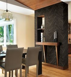 a dining room table and chairs in front of a book shelf