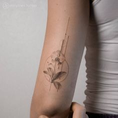 a woman with a flower tattoo on her arm