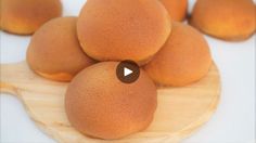 some kind of fruit sitting on top of a wooden plate