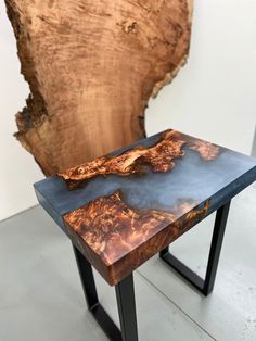 a wooden table sitting on top of a metal stand