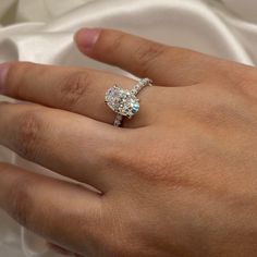 a woman's hand with a diamond ring on it