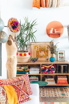 a living room filled with lots of different types of furniture and decor on top of shelves