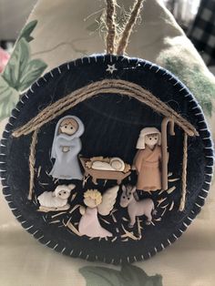 an ornament with nativity scene on it